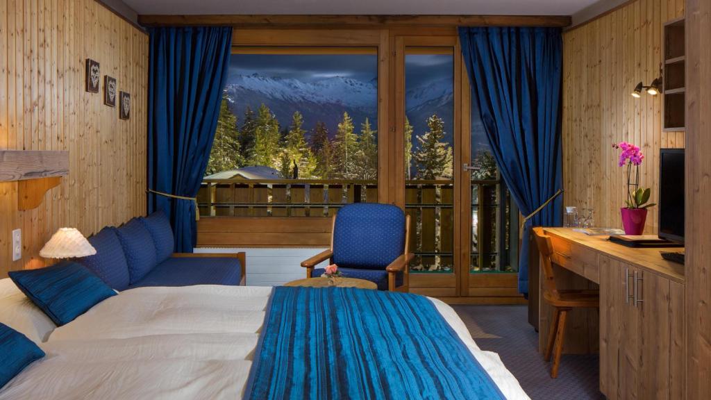 Postel nebo postele na pokoji v ubytování Hotel La Prairie