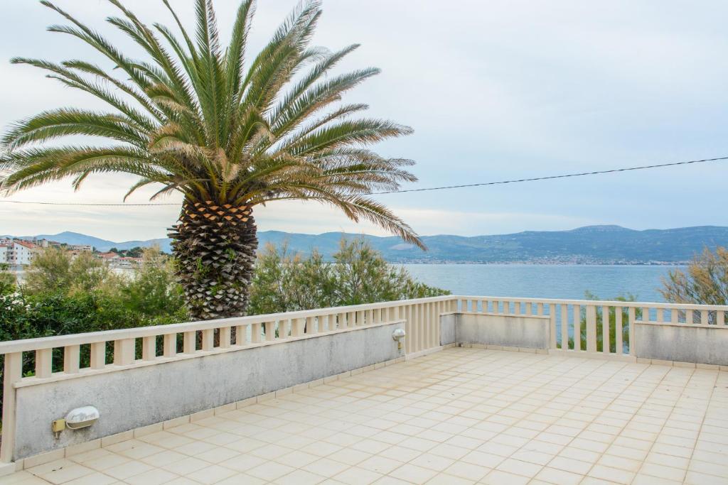 a palm tree on the balcony of a house at Luxury Apartment Kalebic in Slatine