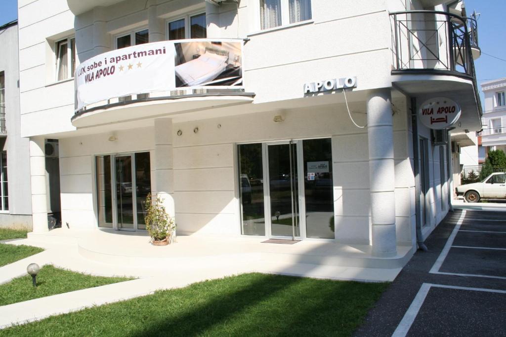 a white building with a sign on it at Vila Apolo in Belgrade