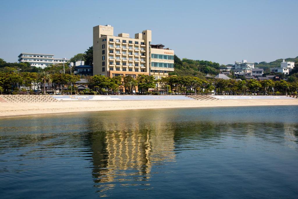 vistas a una playa con un edificio en el fondo en Ryugu Hotel en Nishio