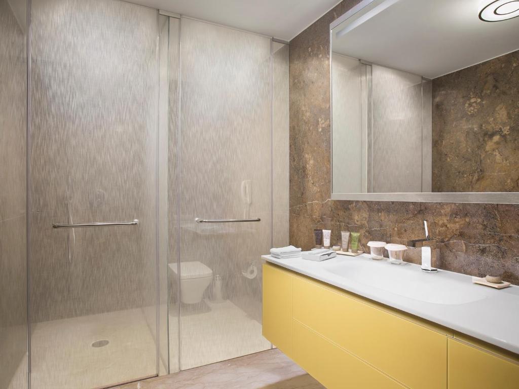 a bathroom with a shower and a sink and a toilet at The Grand Tarabya Managed by Accor in Istanbul