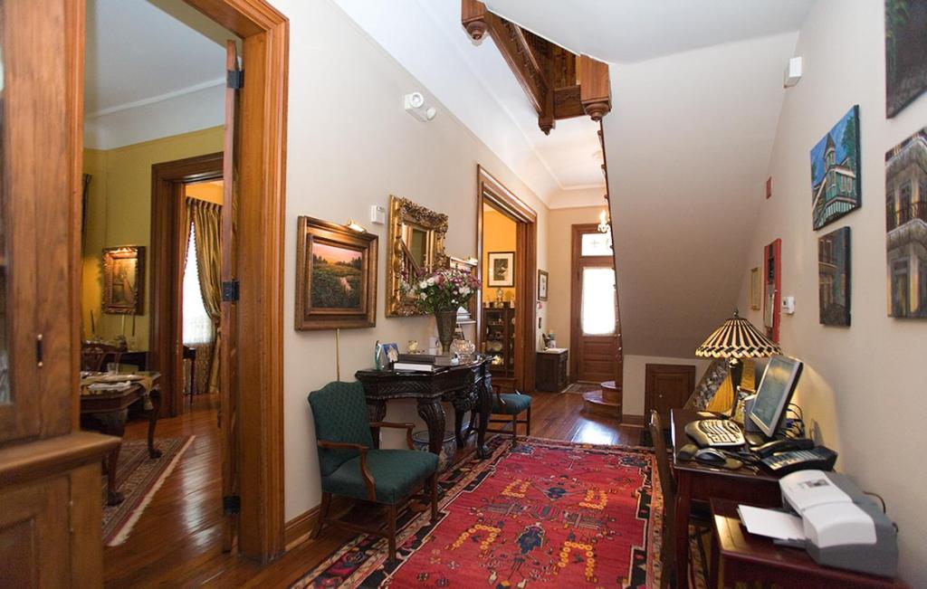 a hallway with a living room with a table at 1896 O'Malley House in New Orleans