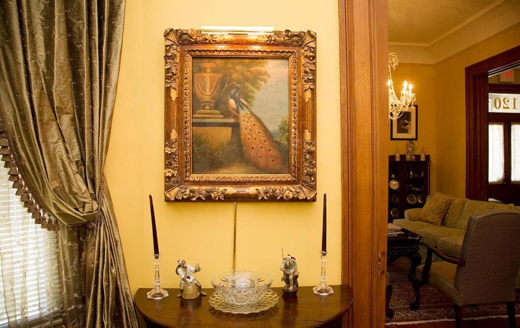 a living room with a painting on the wall and a table at 1896 O'Malley House in New Orleans
