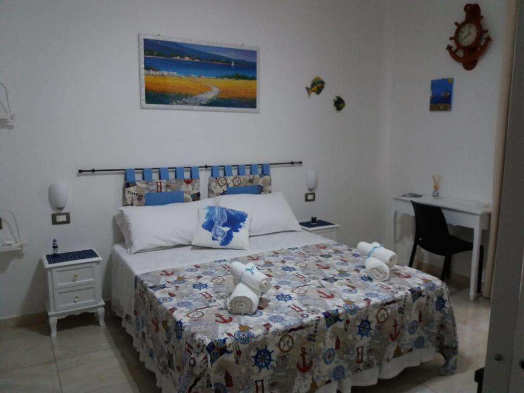 a bedroom with a bed and a desk in it at La Trinacria di Capo Passero in Portopalo