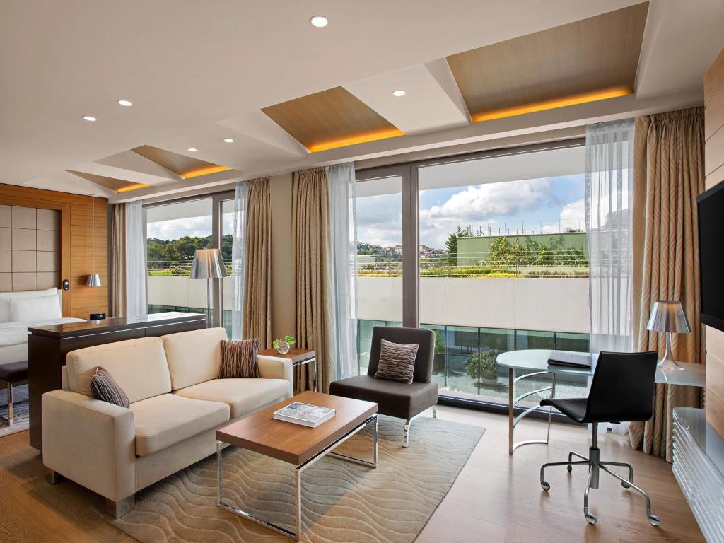 a living room with a couch and a table at The Grand Tarabya Managed by Accor in Istanbul