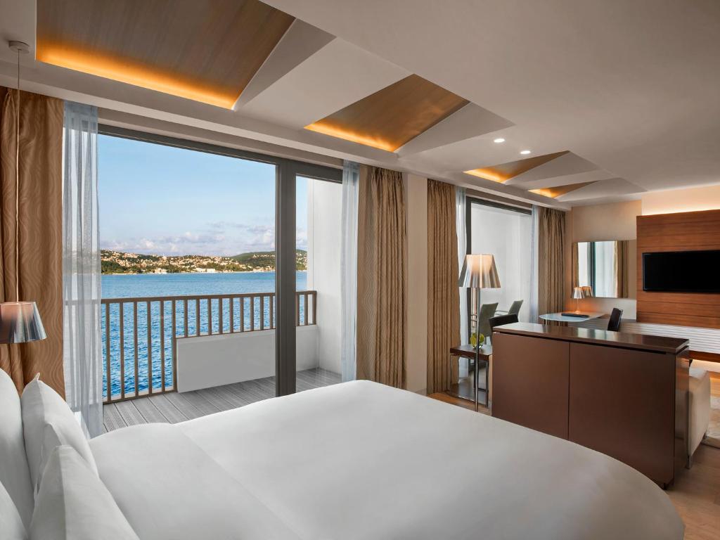 a hotel room with a large bed and a large window at The Grand Tarabya Managed by Accor in Istanbul