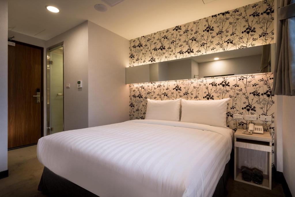 Postel nebo postele na pokoji v ubytování 碩城文旅 SC Hotel