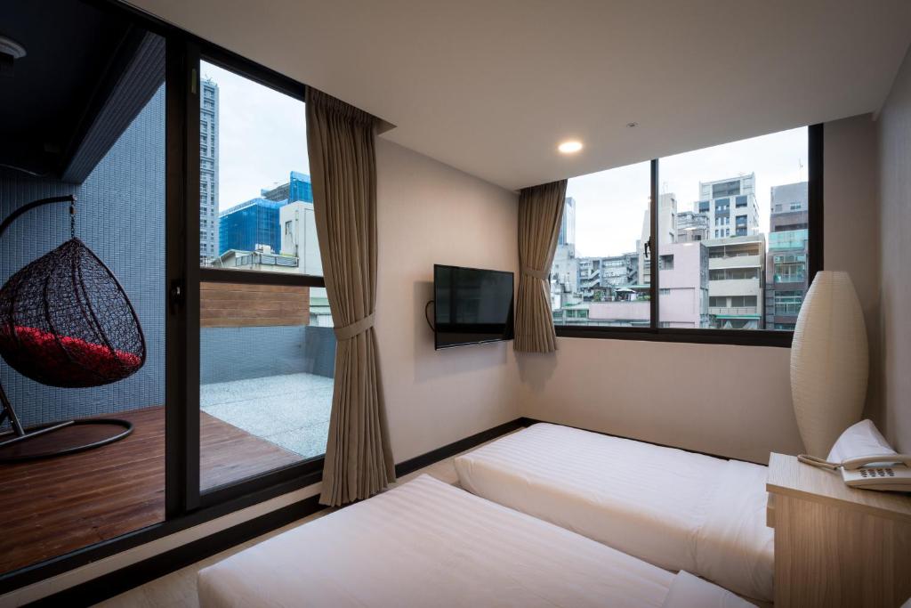 Postel nebo postele na pokoji v ubytování 碩城文旅 SC Hotel