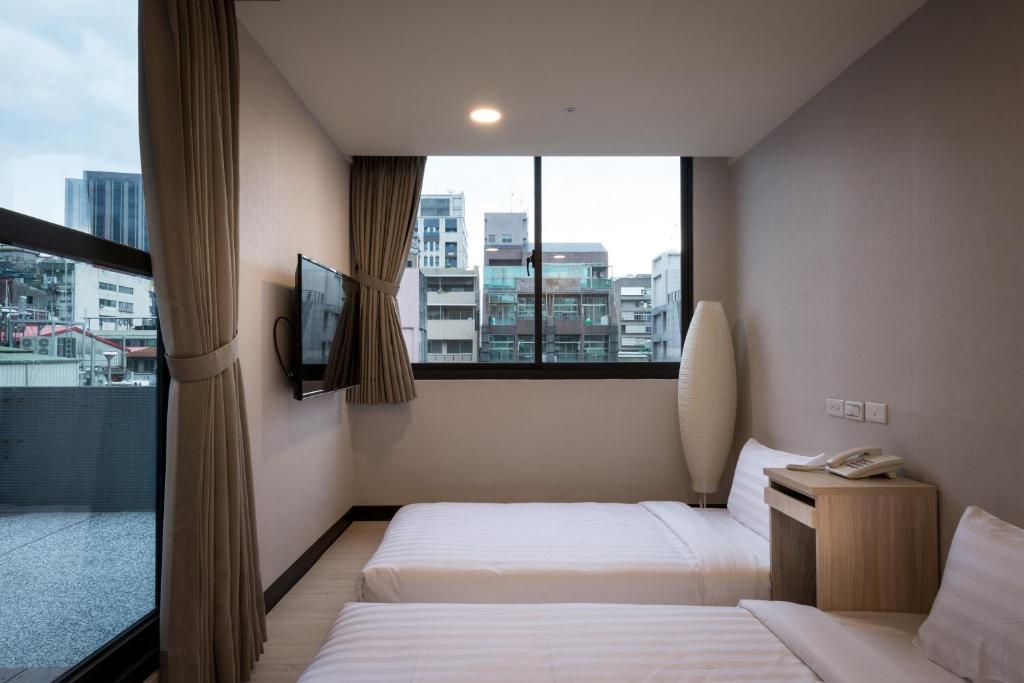 Postel nebo postele na pokoji v ubytování 碩城文旅 SC Hotel