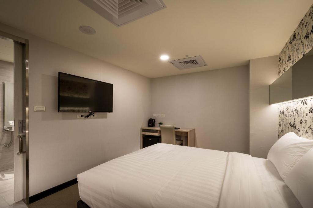 Postel nebo postele na pokoji v ubytování 碩城文旅 SC Hotel