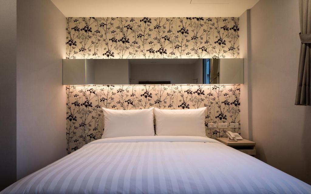 Postel nebo postele na pokoji v ubytování 碩城文旅 SC Hotel