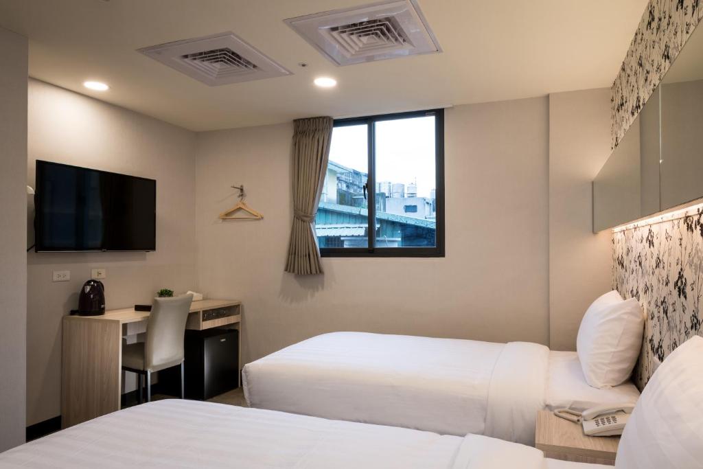 Postel nebo postele na pokoji v ubytování 碩城文旅 SC Hotel