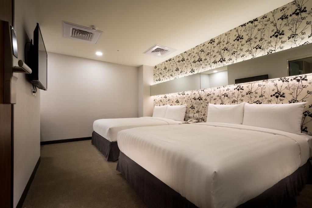 Postel nebo postele na pokoji v ubytování 碩城文旅 SC Hotel