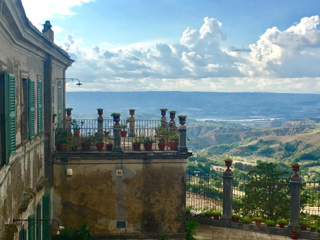 a balcony with potted plants on top of a building at La Corte Di Alice in Lugnano in Teverina