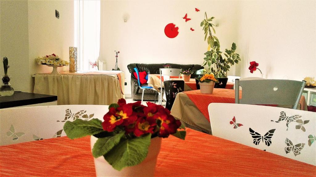 a room with a table with a vase of flowers on it at Mariposa in Telese