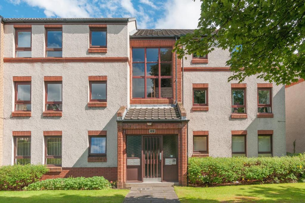 an apartment building with a door in front of it at Polwarth Apartment in Edinburgh