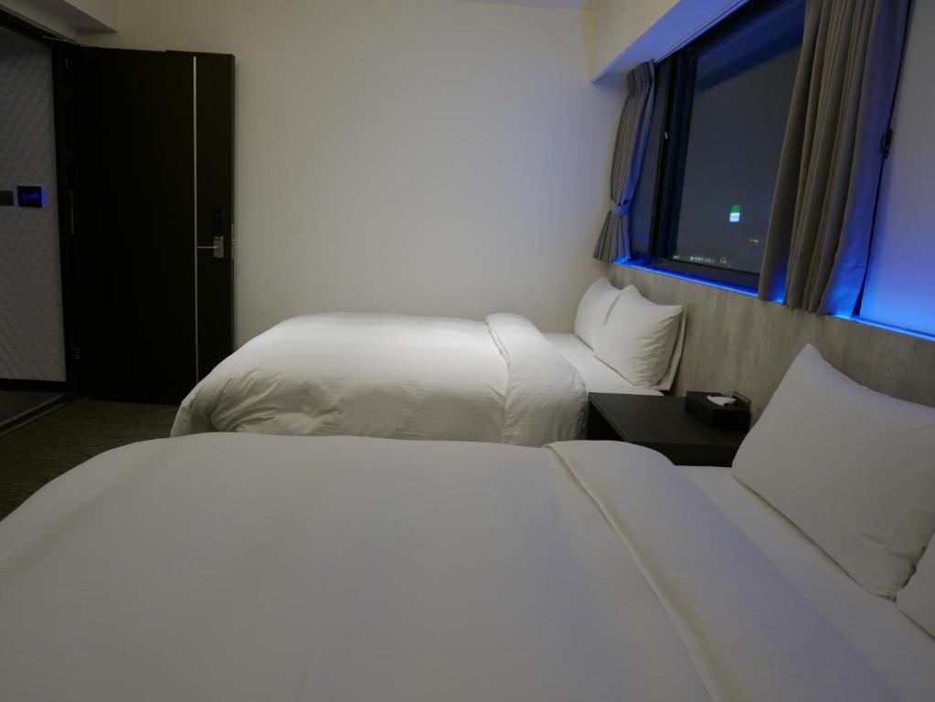 泊居旅店二館 Oursinn Hotel 2にあるベッド