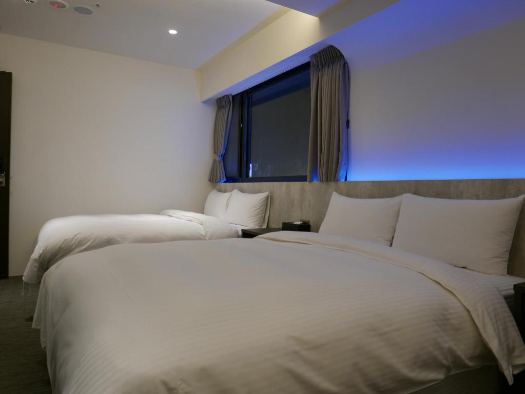 泊居旅店二館 Oursinn Hotel 2にあるベッド
