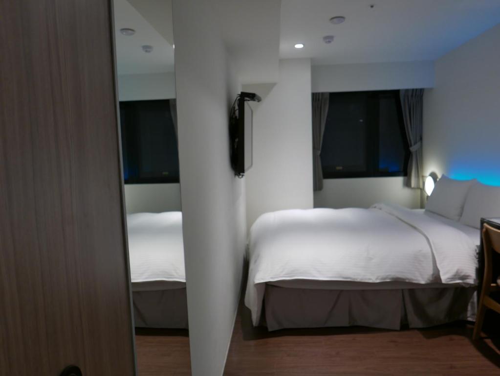 泊居旅店二館 Oursinn Hotel 2にあるベッド