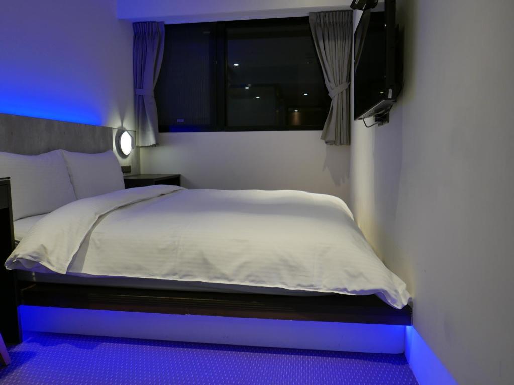 泊居旅店二館 Oursinn Hotel 2にあるベッド