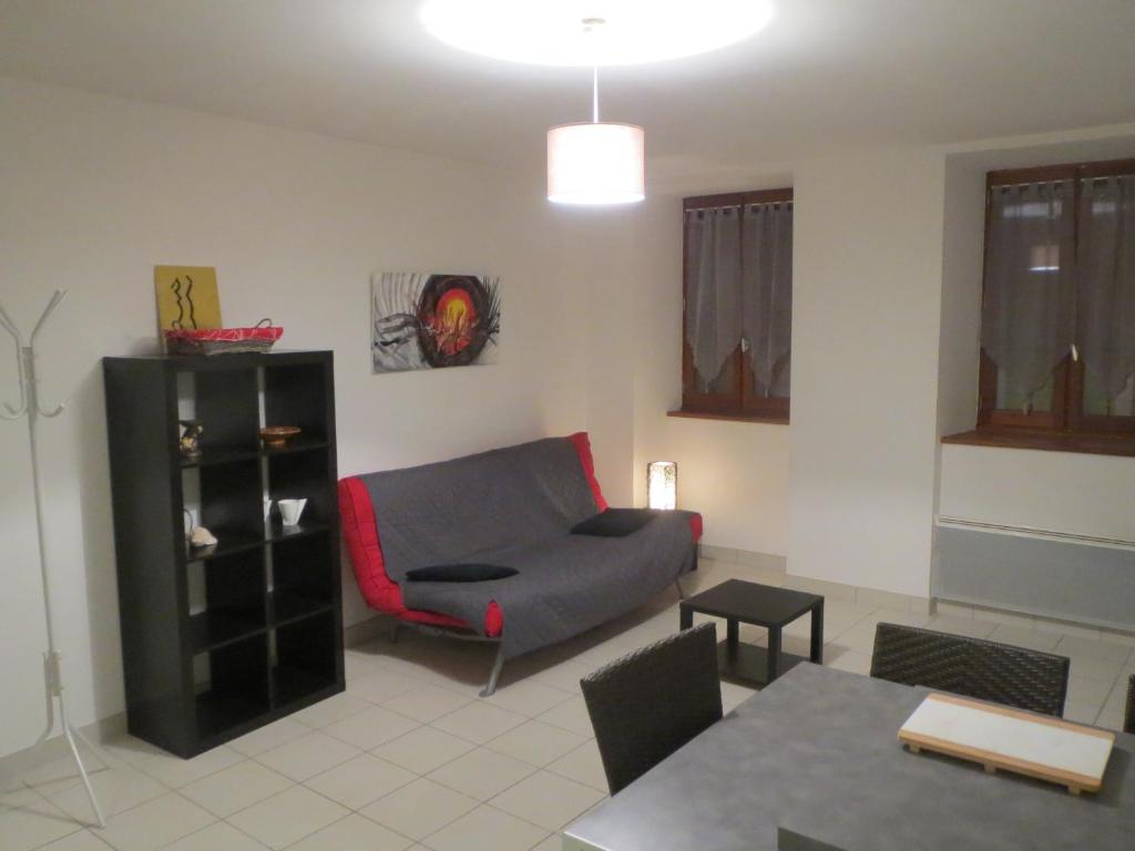オーブナにあるT1 centre ville Aubenasのリビングルーム(ソファ、赤い椅子付)
