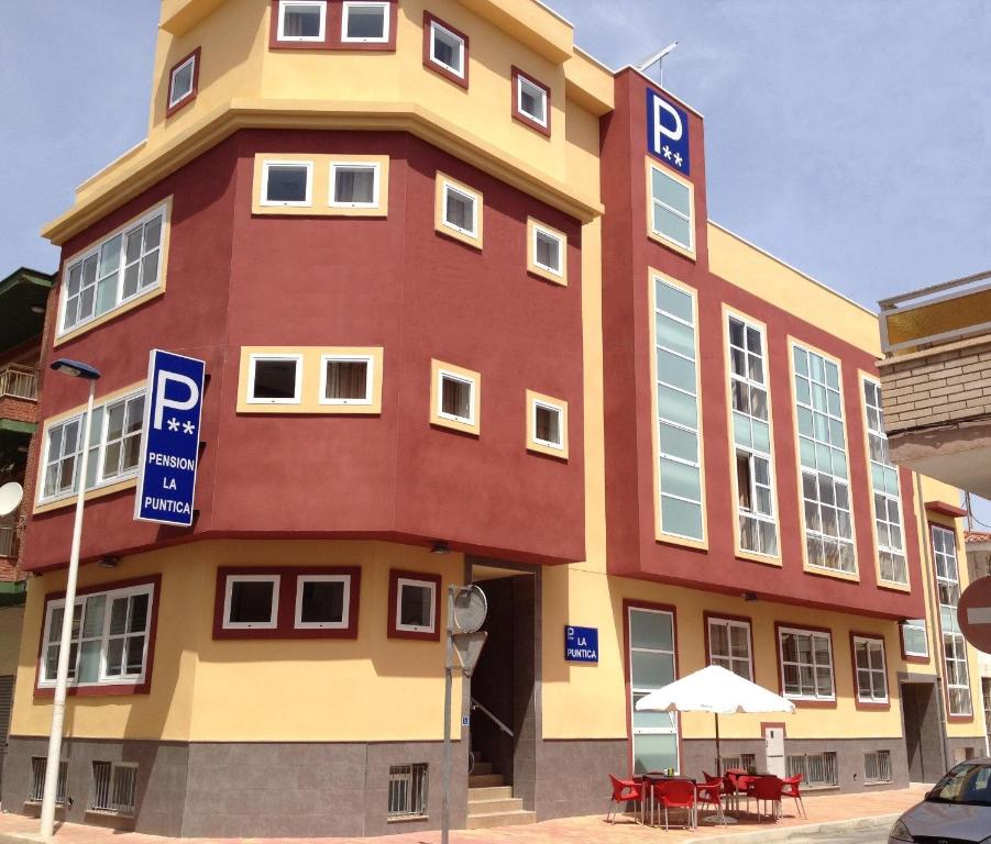 a large building with a sign in front of it at Pension La Puntica in Lo Pagán