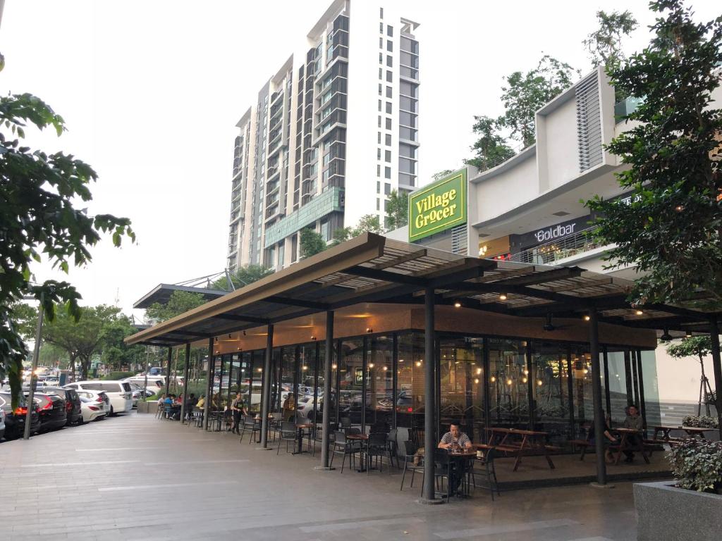 a restaurant with tables and chairs in front of a building at Tropicana Suite in Petaling Jaya