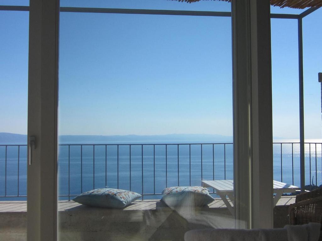 a view of the ocean from the balcony of a house at House Mate in Podgora
