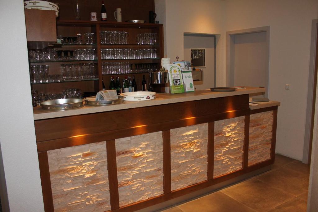 a bar with a counter with lights on it at Gasthof Linde-Classico in Bad Mergentheim