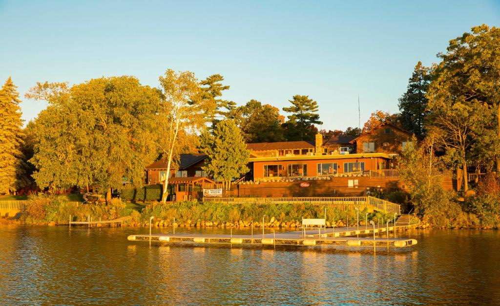 a large house sitting on the side of a lake at Ruttger's Bay Lake Resort in Deerwood