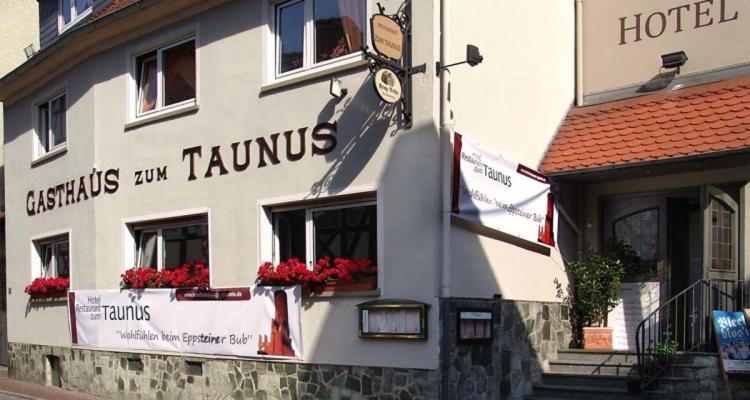 a hotel with flowers in the windows of a building at Hotel zum Taunus in Eppstein