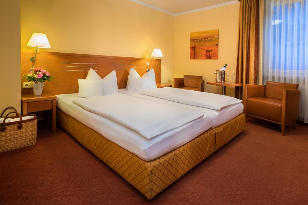 Postel nebo postele na pokoji v ubytování Hotel Vis à vis