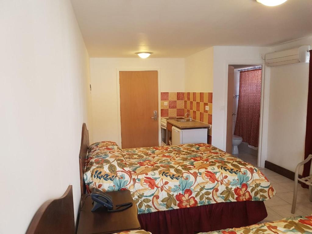 a small bedroom with a bed and a sink at Fantastic Hotel in Marigot