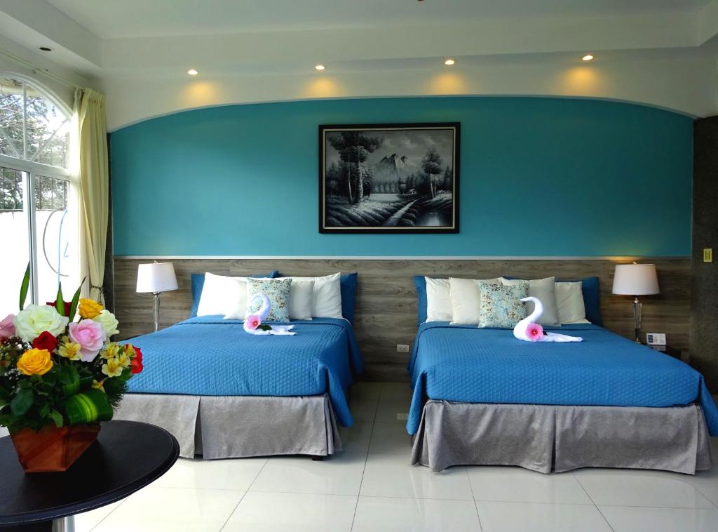 Postel nebo postele na pokoji v ubytování Alameda Cariari Boutique Hotel