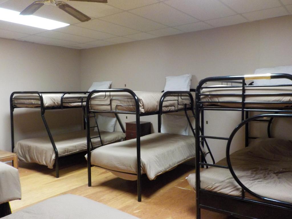 a room with four bunk beds in it at Vernon Hostel in Vernon