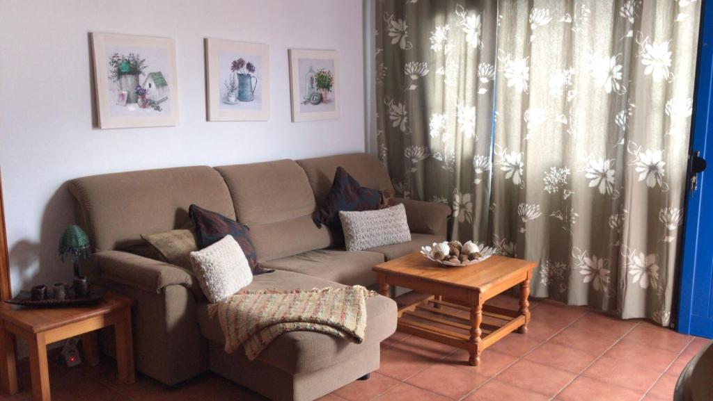 a living room with a couch and a table at Apartamento Inma in Famara