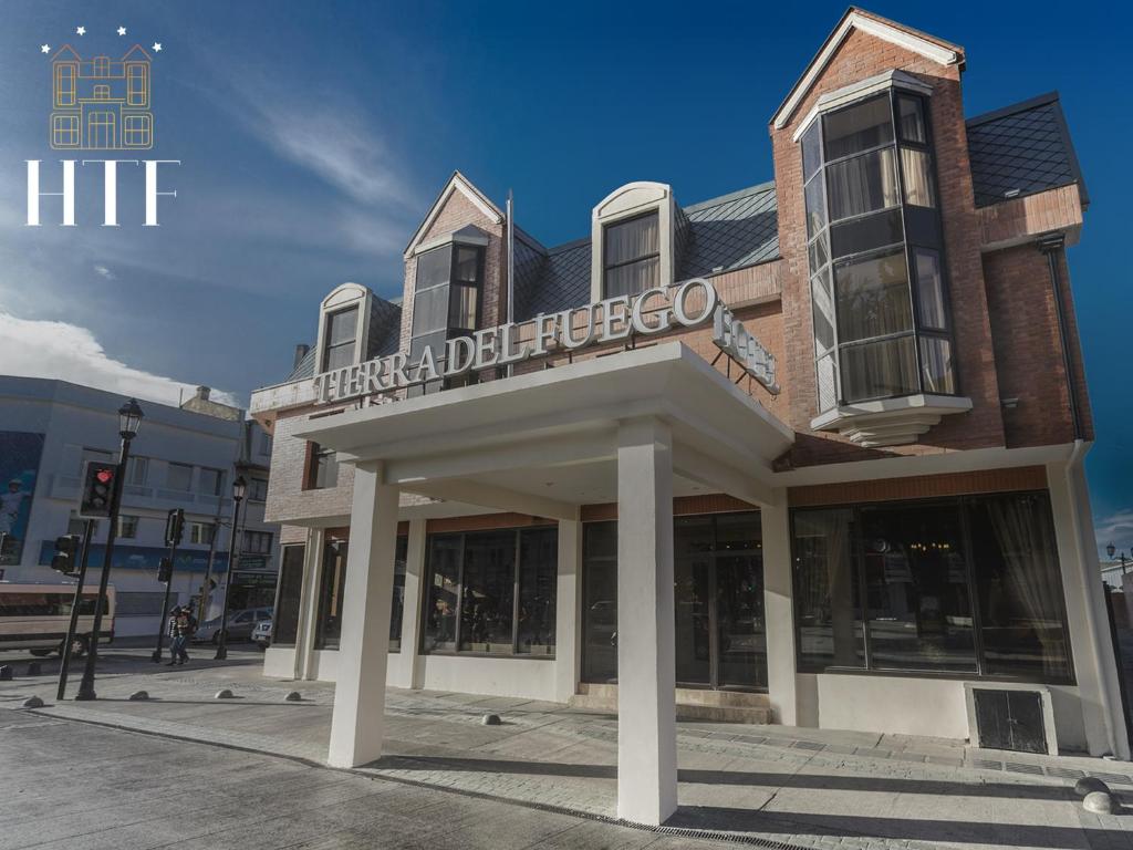 a building with a sign on top of it at Hotel Tierra Del Fuego in Punta Arenas