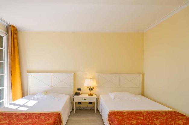 Postel nebo postele na pokoji v ubytování Hotel Villa Cappugi