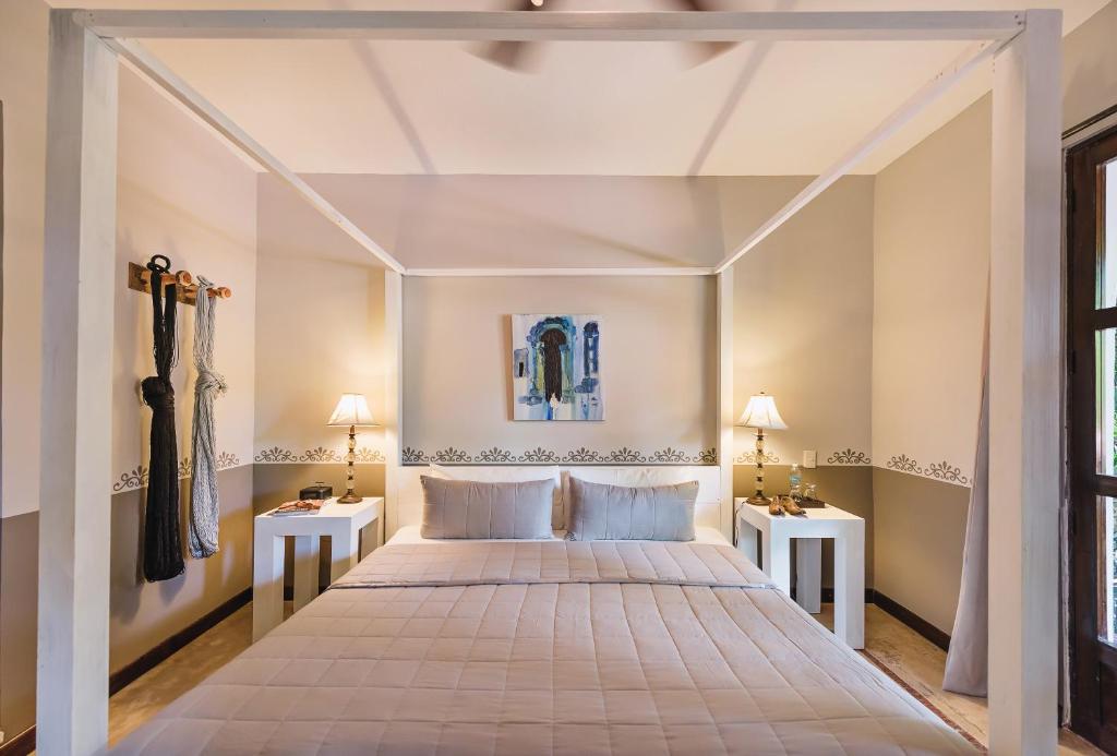 Postel nebo postele na pokoji v ubytování Hotel Hacienda Mérida