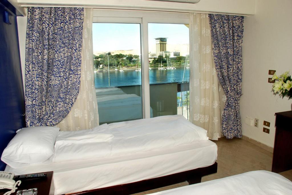 Postel nebo postele na pokoji v ubytování Philae Hotel Aswan