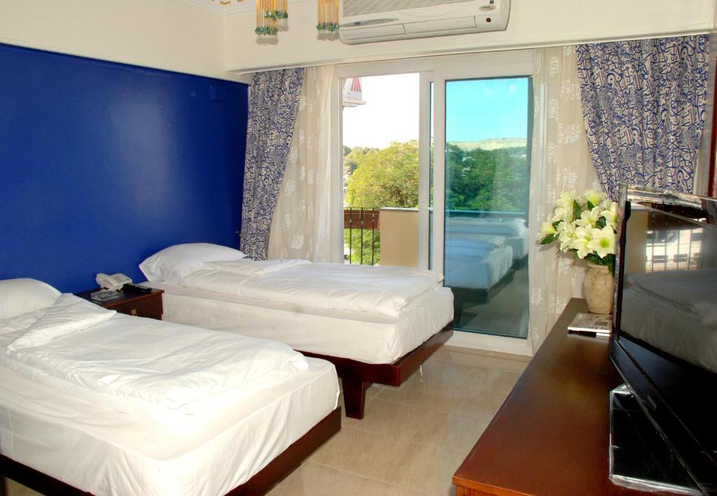 Postel nebo postele na pokoji v ubytování Philae Hotel Aswan