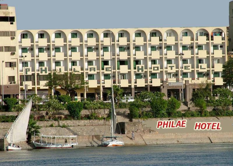 a sail boat in the water in front of a hotel at Philae Hotel Aswan in Aswan