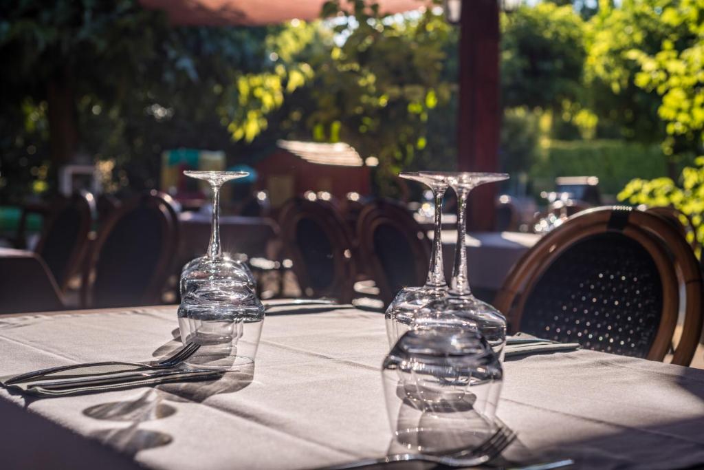 two glass wine glasses sitting on top of a table at Le Clos des Bruyères in Vallon-Pont-dʼArc