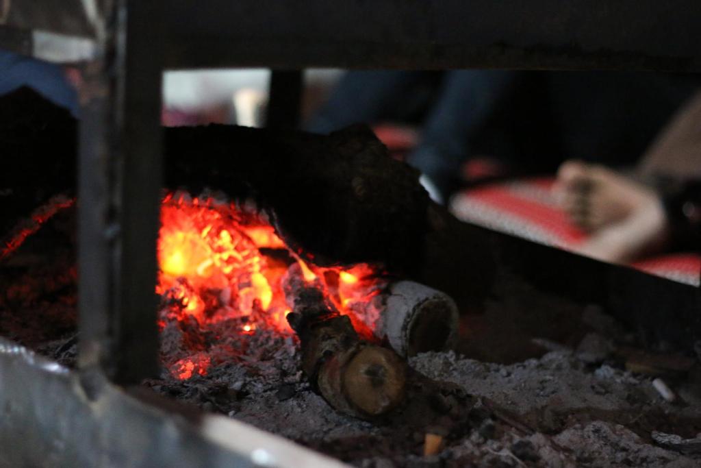 a fire is coming out of a stove at Desert Moon Camp in Wadi Rum