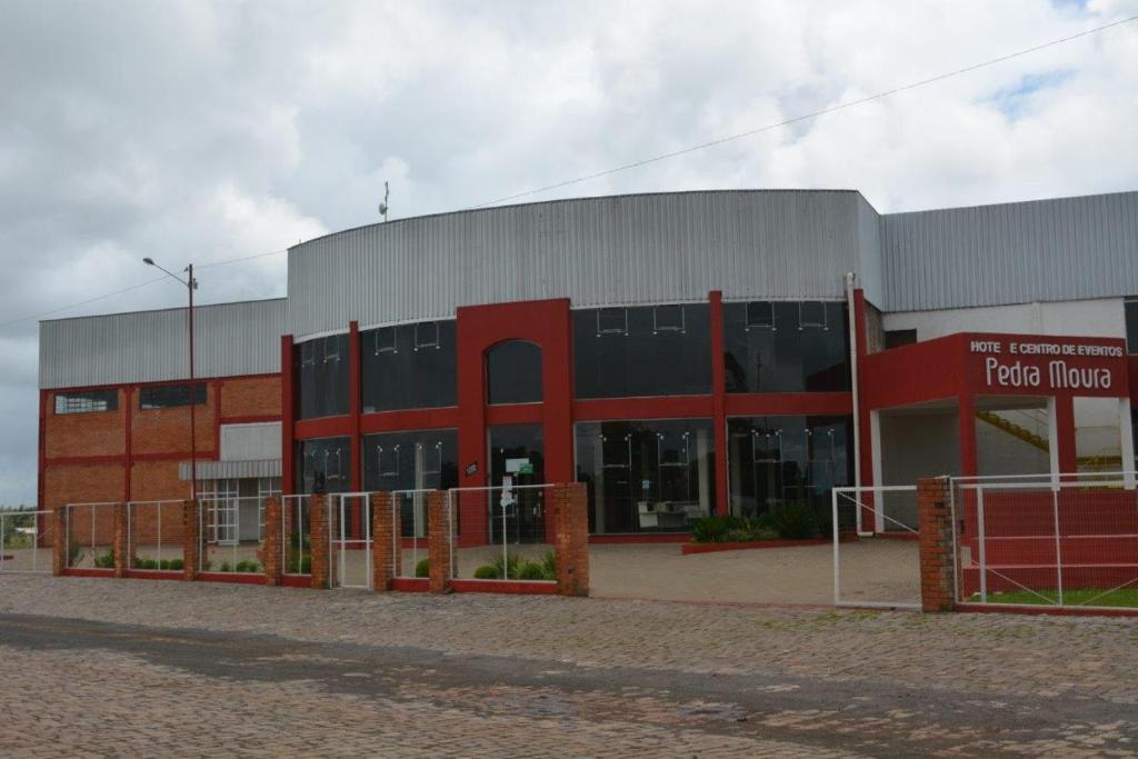 a large red brick building with a sign on it at Hotel Pedra Moura in Vacaria