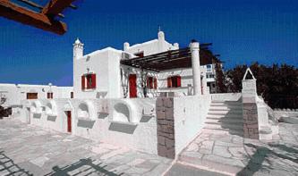 a large white building with red windows and stairs at Villa Vasilis in Mikonos