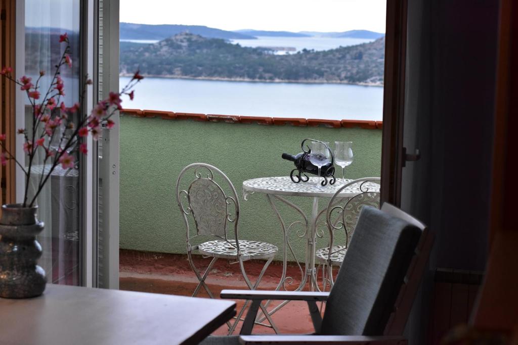 a table and chairs on a balcony with a view at Apartment Rada in Šibenik