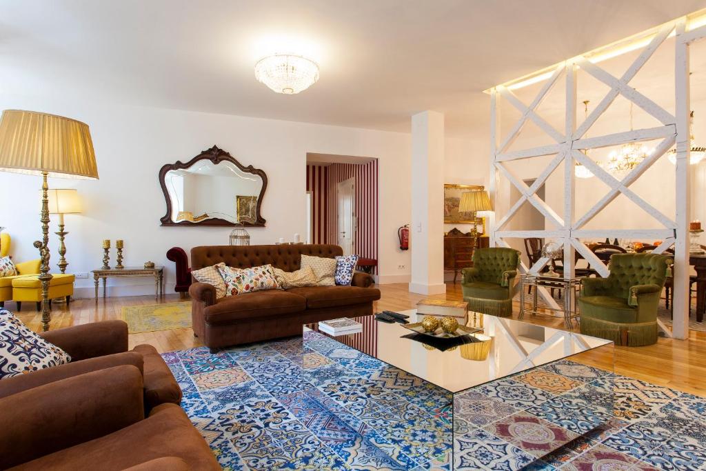 a living room with two couches and a table at Chiado 4-Bedroom Flat in Lisbon