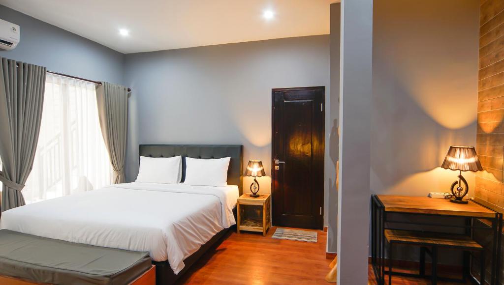 Una cama o camas en una habitación de Bintang Darmawan Villa (BDV)