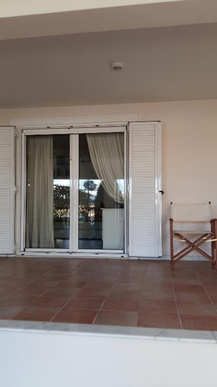an empty living room with a sliding glass door at NN room near the Athens airport in Spata